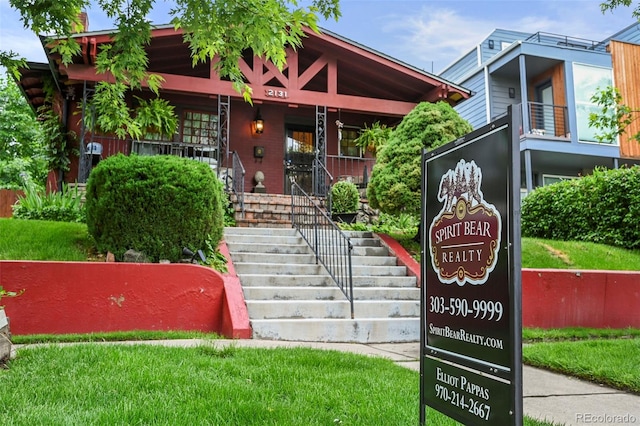 2131 Eliot St, Denver, CO 80211 - view of front facade with a porch, stairs, and a front lawn