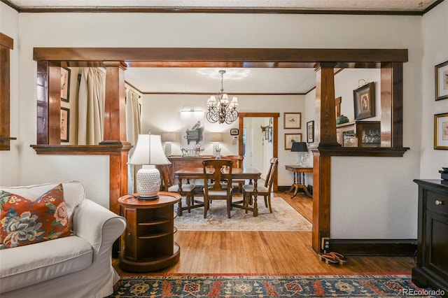 2131 Eliot St, Denver, CO 80211 - dining area with wood finished floors, ornamental molding, and a chandelier