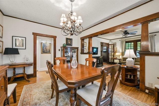 2131 Eliot St, Denver, CO 80211 - dining space with crown molding, light wood-style floors, a chandelier, a textured ceiling, and a ceiling fan