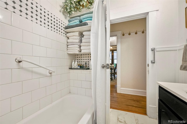 2131 Eliot St, Denver, CO 80211 - full bathroom featuring marble look tiles, vanity, baseboards, and tub / shower combination