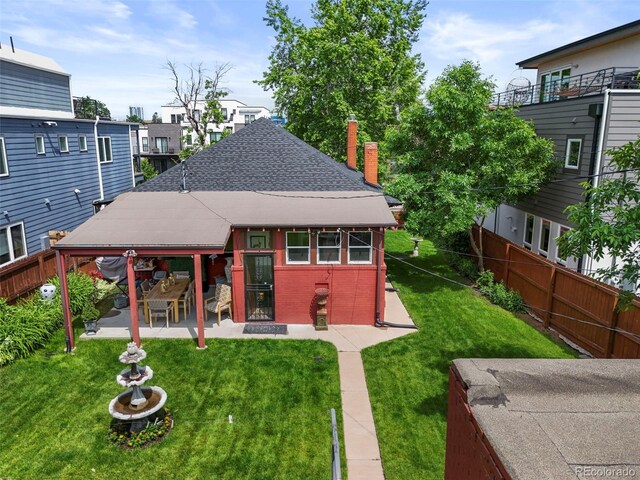 2131 Eliot St, Denver, CO 80211 - back of property featuring a patio, a shingled roof, a chimney, and brick siding