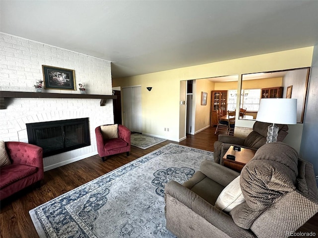 living room with dark hardwood / wood-style floors and a fireplace