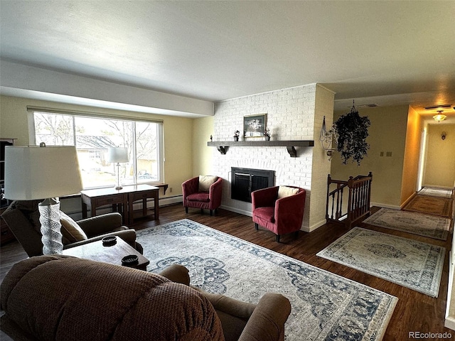 living room with a fireplace and dark wood-type flooring