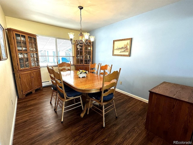 dining area featuring dark wood-type flooring, a chandelier, and a baseboard heating unit