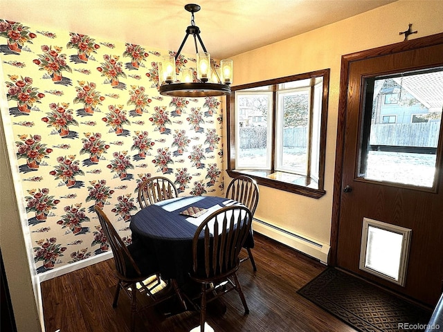 dining space with dark hardwood / wood-style flooring, a baseboard radiator, and a chandelier