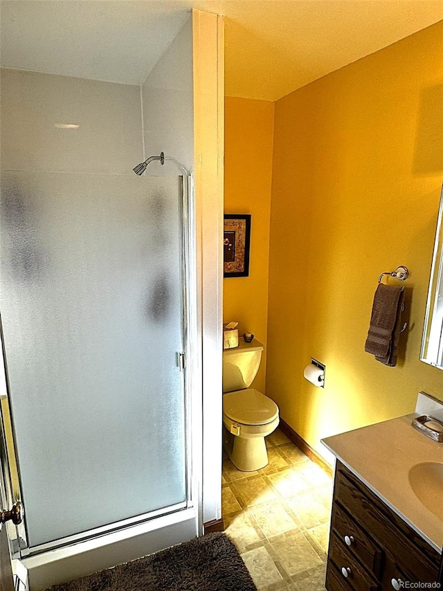 bathroom featuring walk in shower, vanity, and toilet