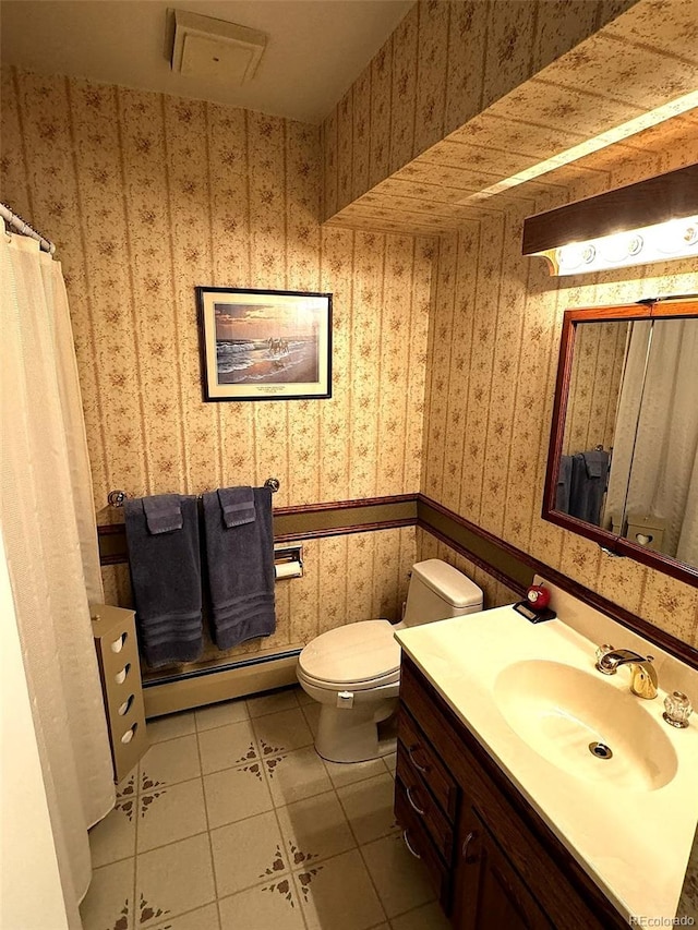 bathroom with vanity, toilet, tile patterned flooring, and a baseboard heating unit