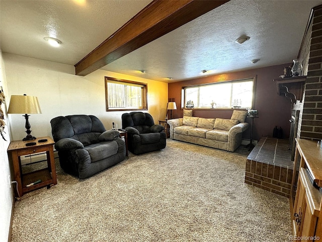 living room with carpet floors, a textured ceiling, and beamed ceiling