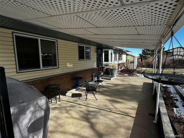 view of patio featuring a pergola and a trampoline