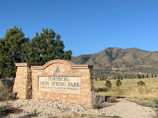 community sign with a mountain view