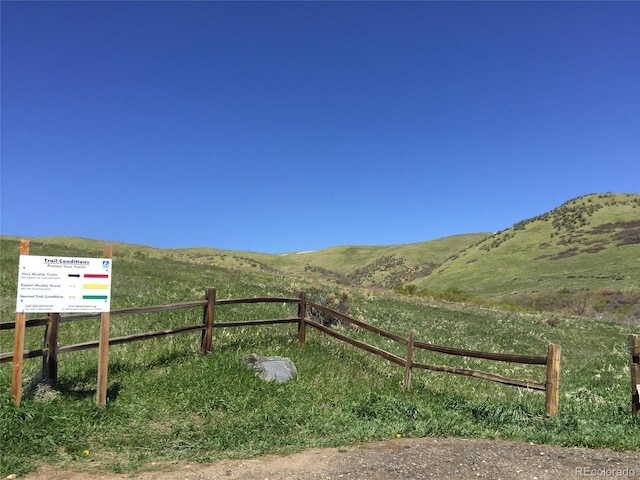 view of gate featuring a rural view and a mountain view