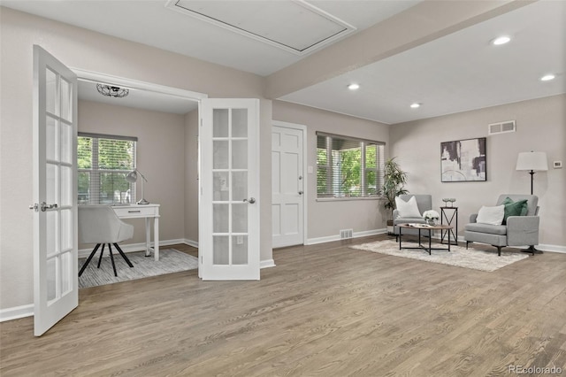 1120 S Harrison St, Denver, CO 80210 - living area featuring french doors, plenty of natural light, wood finished floors, and recessed lighting