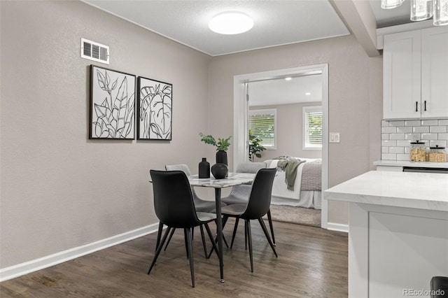 1120 S Harrison St, Denver, CO 80210 - dining area with dark wood-style flooring and a textured wall