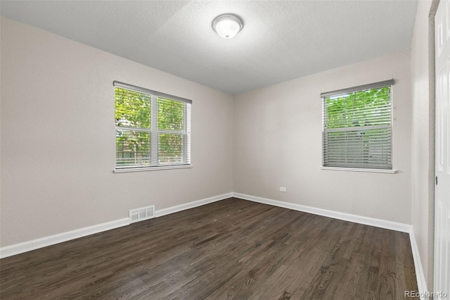 1120 S Harrison St, Denver, CO 80210 - spare room with dark wood-style floors and a textured ceiling