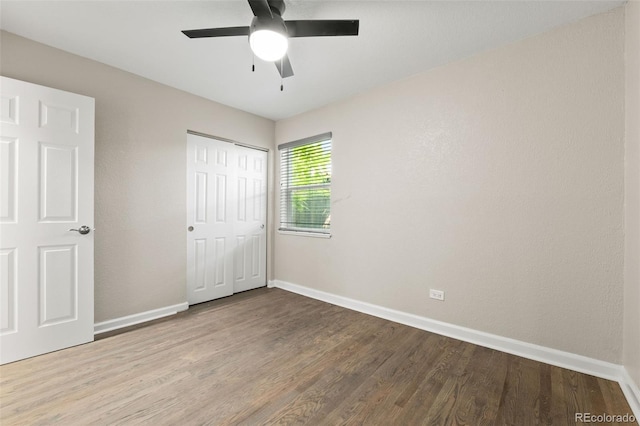 1120 S Harrison St, Denver, CO 80210 - unfurnished bedroom featuring wood finished floors, a closet, and ceiling fan