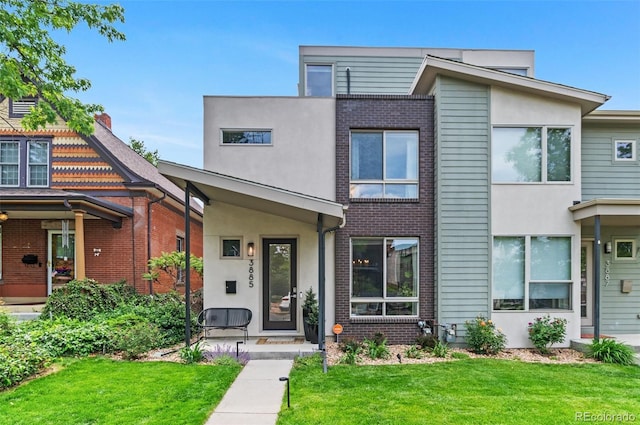 3885 Vrain St, Denver, CO 80212 - view of front facade with a front lawn, stucco siding, and brick siding