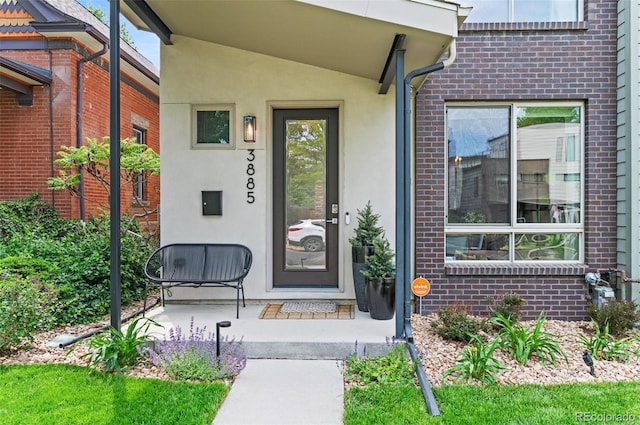3885 Vrain St, Denver, CO 80212 - entrance to property featuring brick siding, stucco siding, and covered porch