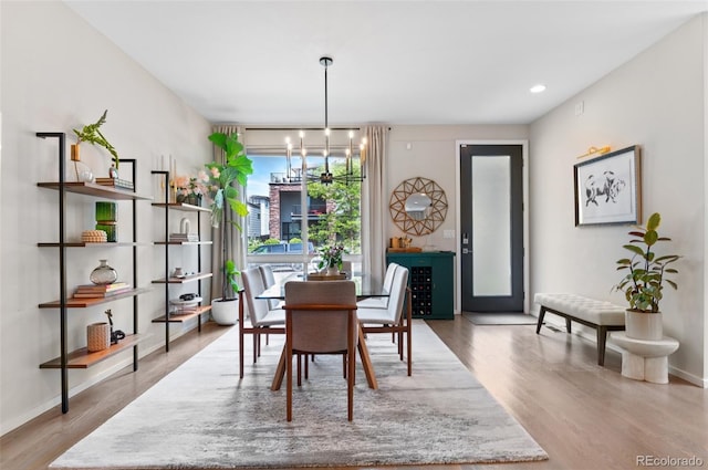 3885 Vrain St, Denver, CO 80212 - dining area featuring wood finished floors, a chandelier, and baseboards