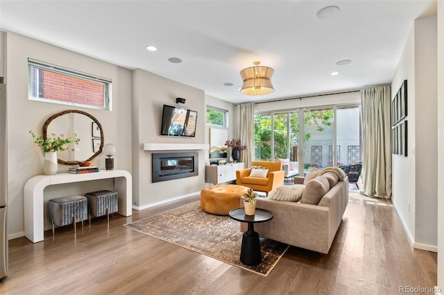 3885 Vrain St, Denver, CO 80212 - living area with a glass covered fireplace, baseboards, wood finished floors, and recessed lighting