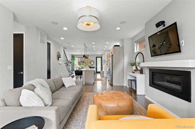 3885 Vrain St, Denver, CO 80212 - living area featuring healthy amount of natural light, dark wood-style flooring, recessed lighting, a glass covered fireplace, and baseboards