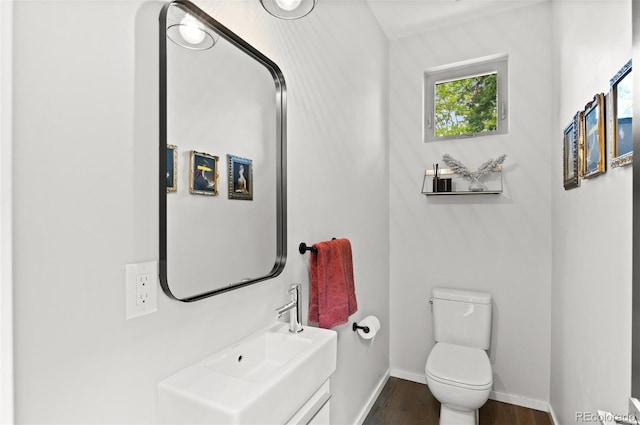 3885 Vrain St, Denver, CO 80212 - half bathroom with wood finished floors, toilet, baseboards, and vanity