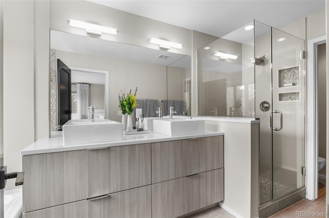 3885 Vrain St, Denver, CO 80212 - bathroom with double vanity, a stall shower, toilet, and recessed lighting