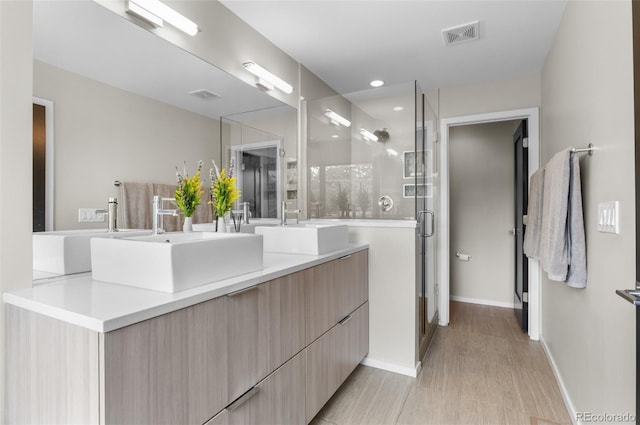 3885 Vrain St, Denver, CO 80212 - full bath featuring double vanity, a stall shower, wood finished floors, baseboards, and recessed lighting