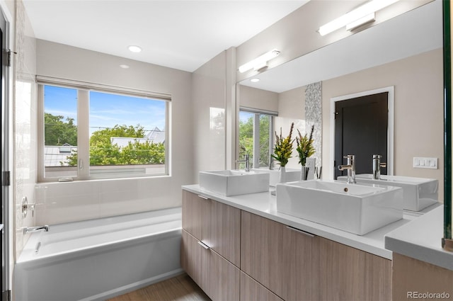 3885 Vrain St, Denver, CO 80212 - full bathroom with a bath, double vanity, and wood finished floors