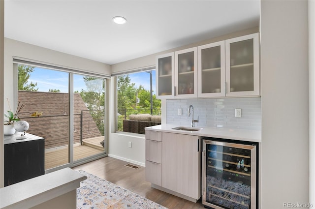 3885 Vrain St, Denver, CO 80212 - indoor wet bar with beverage cooler, plenty of natural light, wood finished floors, decorative backsplash, and recessed lighting