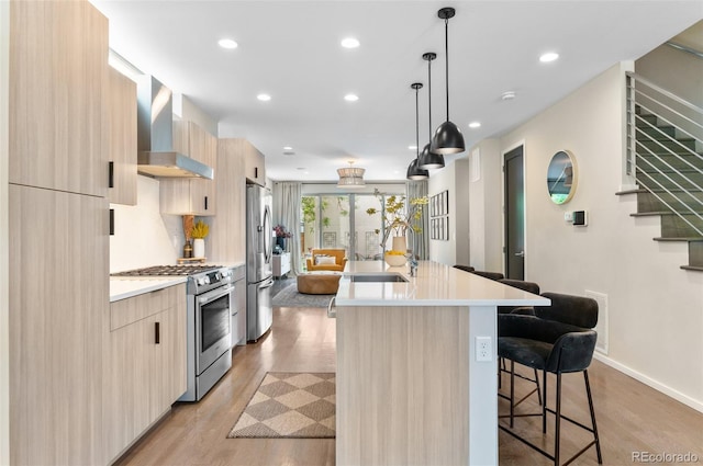 3885 Vrain St, Denver, CO 80212 - kitchen with stainless steel appliances, modern cabinets, wall chimney exhaust hood, a sink, and an island with sink