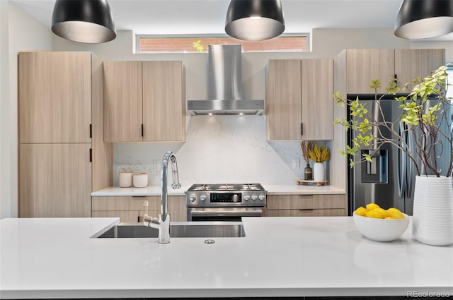 3885 Vrain St, Denver, CO 80212 - kitchen featuring wall chimney exhaust hood, stainless steel appliances, light countertops, light brown cabinetry, and a sink