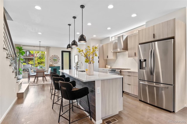 3885 Vrain St, Denver, CO 80212 - kitchen with appliances with stainless steel finishes, wall chimney range hood, modern cabinets, light brown cabinetry, and a sink
