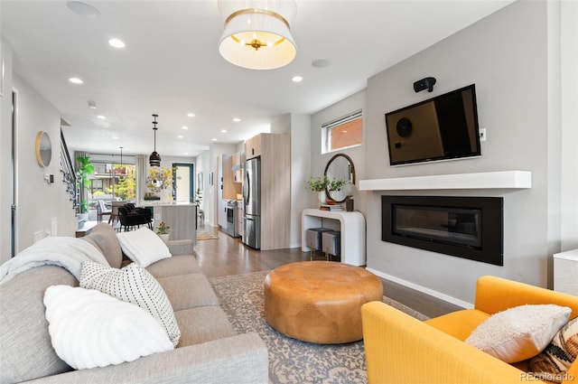 3885 Vrain St, Denver, CO 80212 - living room featuring dark wood finished floors, recessed lighting, a glass covered fireplace, and baseboards