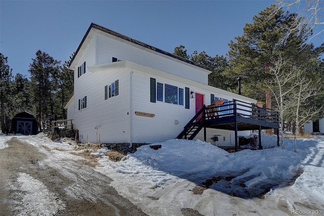 view of front of house featuring a shed, stairway, an outdoor structure, and a wooden deck