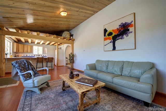 living area featuring baseboards, arched walkways, lofted ceiling, wood ceiling, and wood finished floors