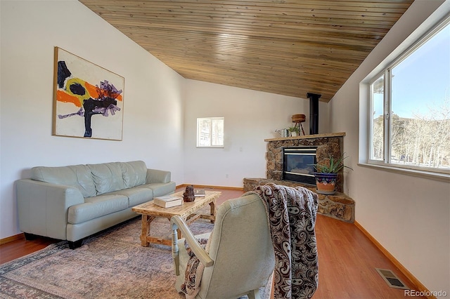 living room featuring visible vents, wood ceiling, vaulted ceiling, wood finished floors, and baseboards