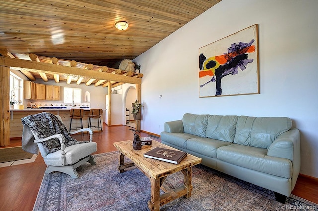 living area with arched walkways, wooden ceiling, baseboards, vaulted ceiling, and dark wood finished floors