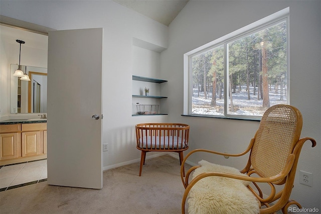 sitting room featuring light tile patterned flooring, baseboards, vaulted ceiling, and light colored carpet