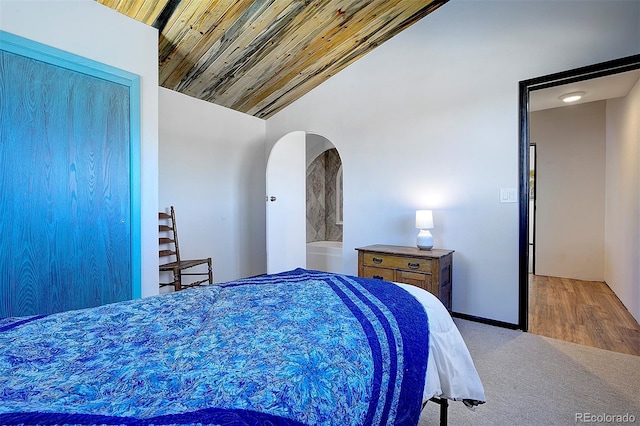 bedroom with lofted ceiling, wooden ceiling, and carpet flooring