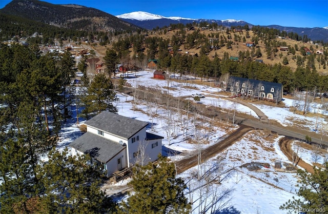 snowy aerial view featuring a mountain view