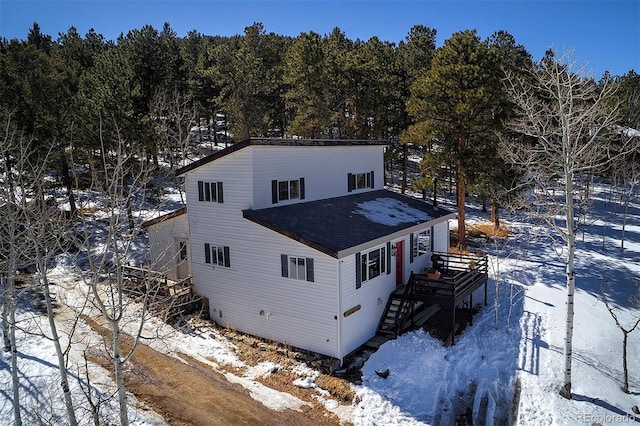 exterior space with roof with shingles