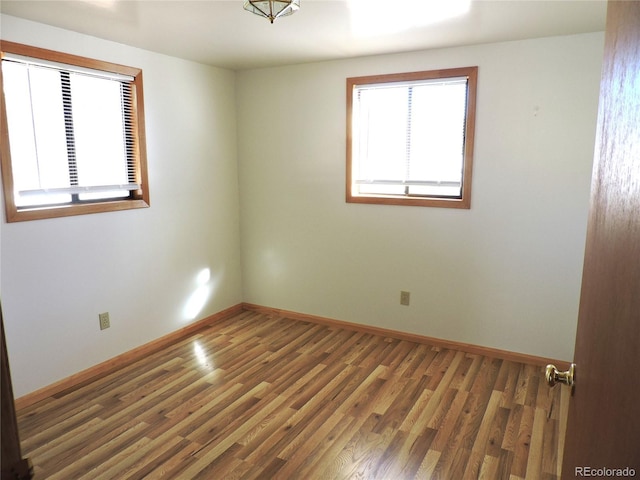 unfurnished room featuring dark hardwood / wood-style flooring