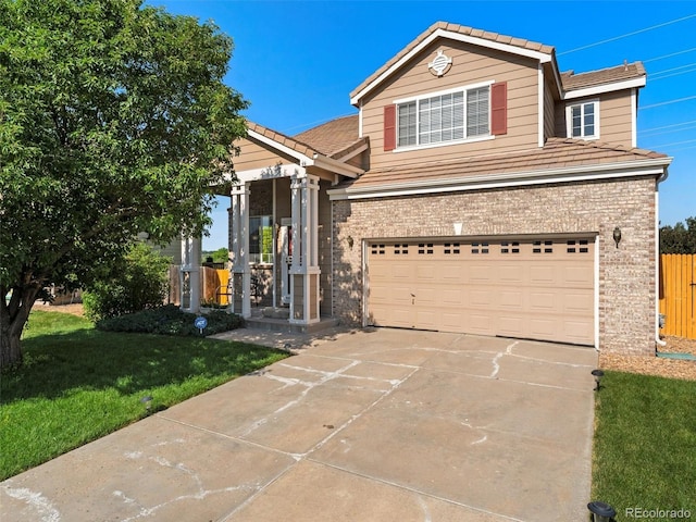 18554 E Vassar Dr, Aurora, CO 80013 - traditional-style house with brick siding, driveway, a garage, and a tile roof