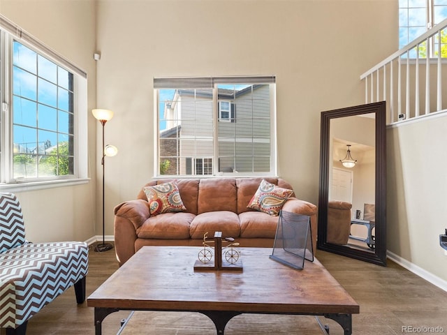 18554 E Vassar Dr, Aurora, CO 80013 - living area with a high ceiling, wood finished floors, and plenty of natural light