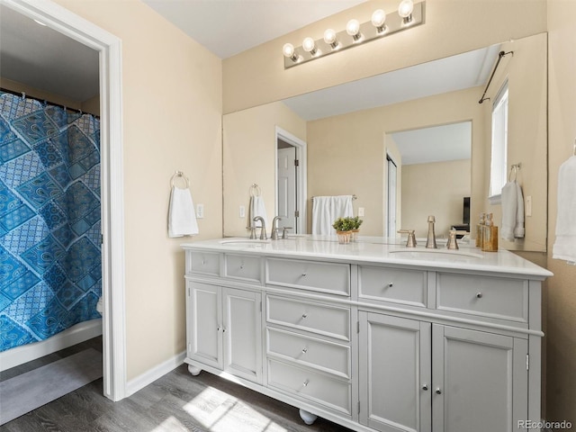 18554 E Vassar Dr, Aurora, CO 80013 - full bath featuring wood finished floors, double vanity, and curtained shower