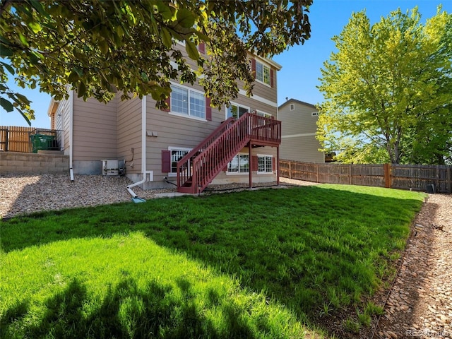 18554 E Vassar Dr, Aurora, CO 80013 - back of property with stairway, a fenced backyard, and a deck
