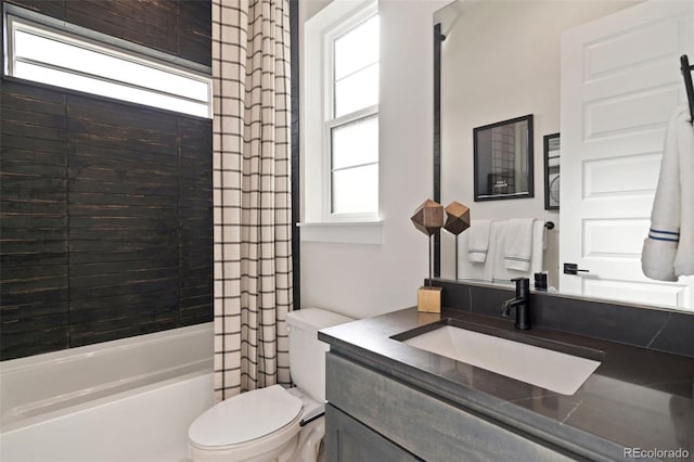 full bathroom featuring vanity, shower / tub combo, a wealth of natural light, and toilet