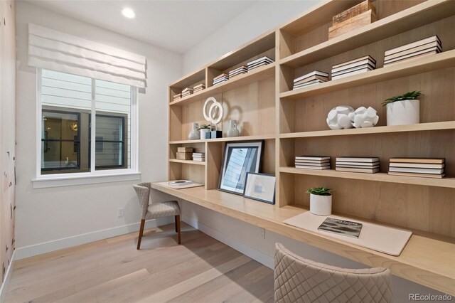 office area with light hardwood / wood-style flooring and built in desk