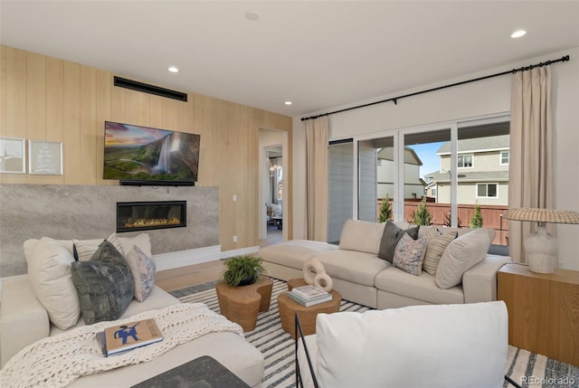 living room featuring wood-type flooring and wooden walls