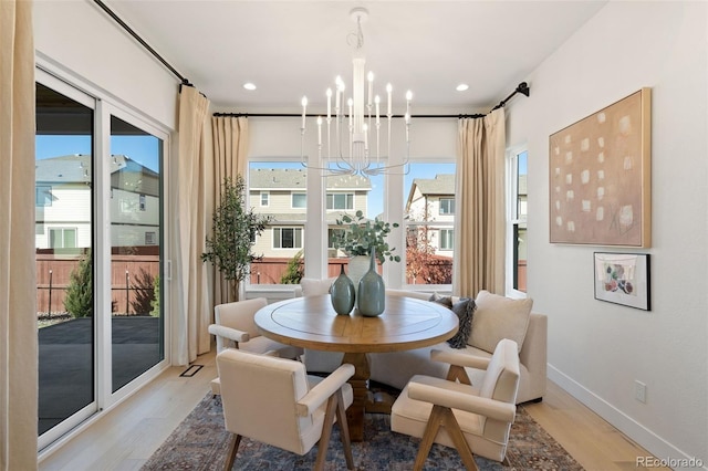 dining space featuring a notable chandelier and light hardwood / wood-style flooring